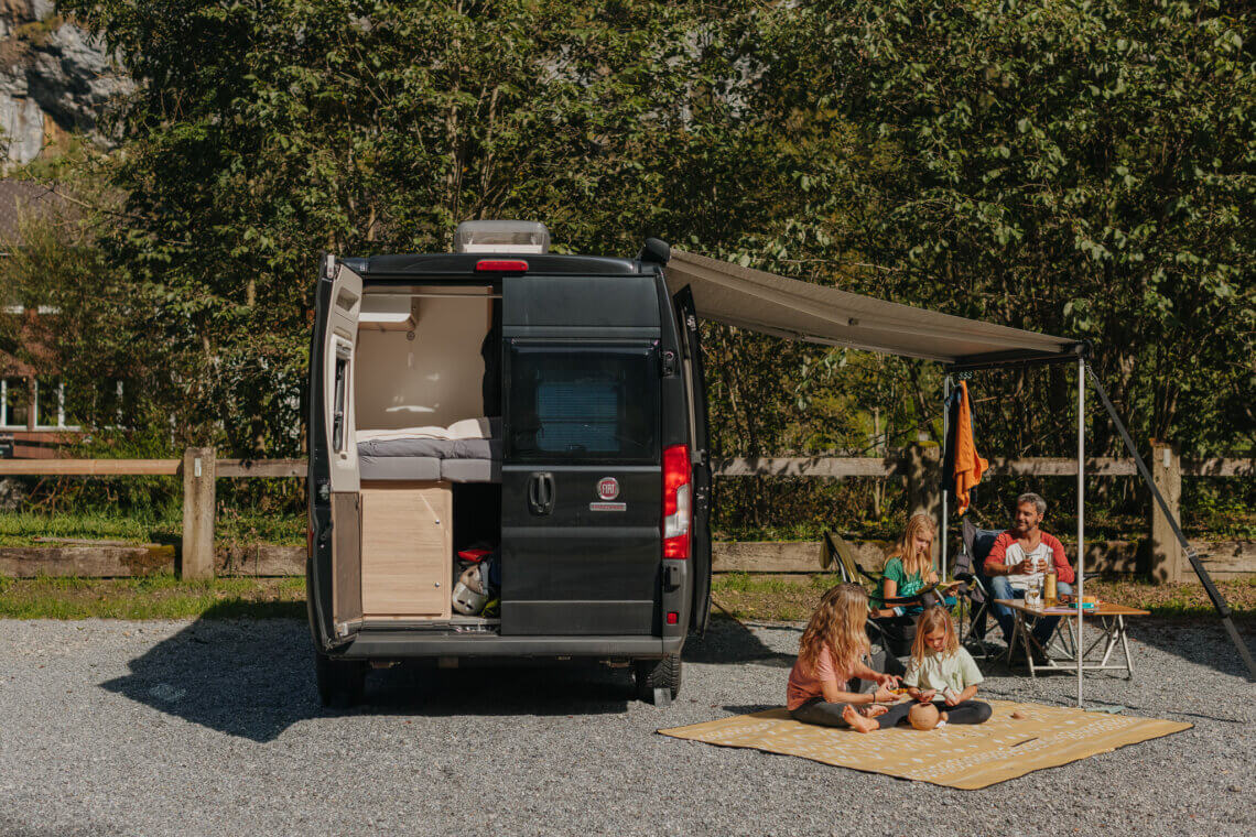 Family-with-camper-van-on-pitch