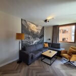 De woonkamer met een relaxstoel en (slaap-)bank